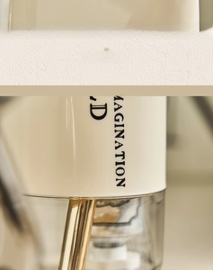 Detail of portable wash cup featuring a silver top handle and minimalist lettering
