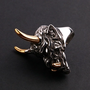 Detail shot of vintage bull skull ring with gold horns and polished silver finish