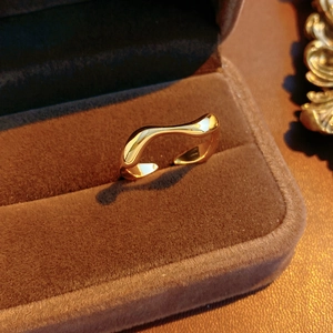 Macro shot of 18k gold plated irregular square open ring in a luxury velvet jewelry box