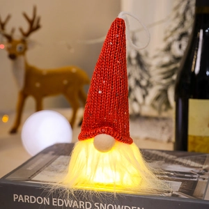Detail of a Christmas gnome with a red sequin hat and warm LED glowing beard decor