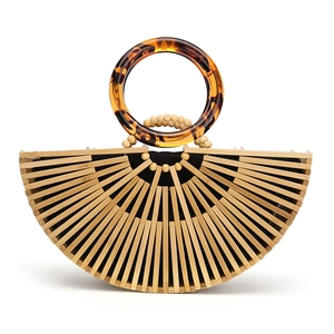 Detail of bamboo fan bag featuring tortoiseshell acrylic handles and wooden bead accents