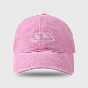 Close-up of vintage pink washed denim baseball cap with white SD letter embroidery detail