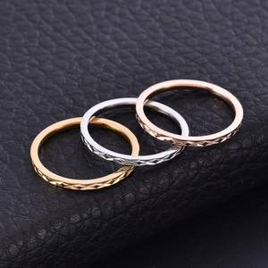 Three 18K gold-plated titanium steel rings with diamond-cut texture in various colors