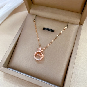 Rose gold pipa necklace with moving central gemstone and pave setting in a gift box