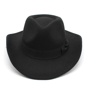 Top view of premium black wool felt cowboy hat with classic crown and ribbon trim