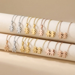 Detail view of boy and girl silhouette charms in gold, silver and rose gold steel