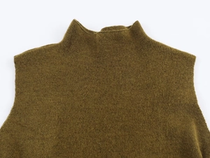 Close-up of olive green mohair knit top showing turtle neck and soft wool texture