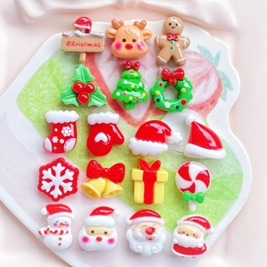 Mini resin Christmas charms including Santa and reindeer displayed on a heart-shaped plate