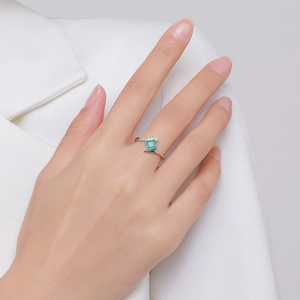 Elegant S925 silver ring featuring a rectangular emerald gemstone on model's finger