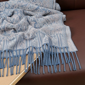 Detailed view of soft core-spun yarn scarf with blue beige pattern and fringe tassels
