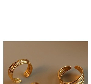 Detail of gold-plated multi-layer crisscross rings with an open adjustable design