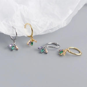 Macro shot of S925 silver earrings with colorful zircon pendants in gold and silver finish