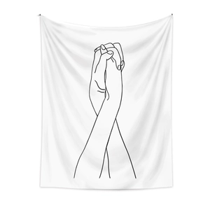 Detail of minimalist black line art on white tapestry showing intimate intertwined hands