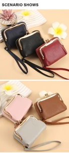 Detail view of lychee leather card holder with wrist strap and metal zipper closure
