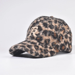 Detailed view of leopard print plush baseball cap with embroidered letter R emblem