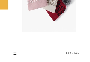 Close-up of winter knit beanies with geometric jacquard patterns and faux fur pom-pom