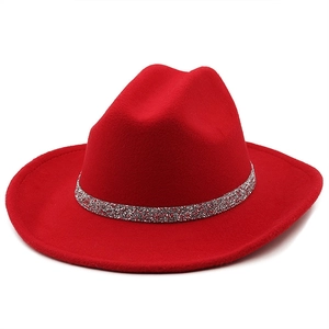 Detail of red wool felt fedora featuring a sparkling silver rhinestone decorative band