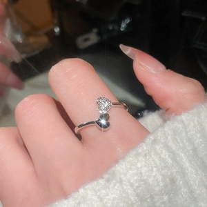 Detail of 18k silver plated double heart ring featuring cubic zirconia on model finger