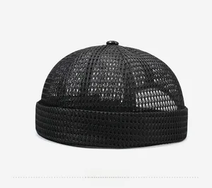 Detail view of the breathable mesh texture and thick folded brim on a black docker cap