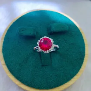 Macro shot of 2-carat red gemstone ring with petal-shaped setting in velvet box