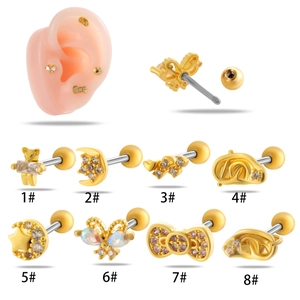 Detail view of 8 gold cartilage studs with moon and bow designs featuring zircon stones