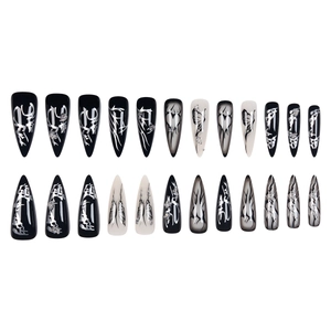 Gothic punk press-on nails with silver butterfly and heart patterns on long stiletto tips