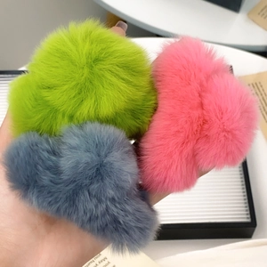 Plush faux rabbit fur hair claw clips in green, pink, and blue-grey for women