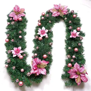 Macro detail of 2.7m Christmas garland with pink poinsettia flowers and rose gold ornaments