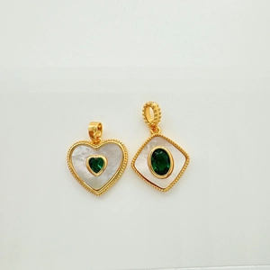 Gold-plated shell pendants with green gemstones in heart and diamond shapes on white background