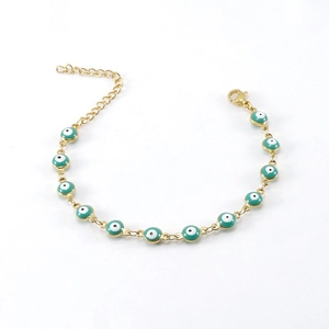 Detail of gold evil eye bracelet with turquoise enamel beads and lobster clasp closure