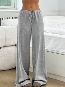 Detail of grey knitted wide-leg lounge pants featuring a drawstring high waist design