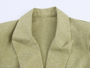 Close-up of lapel detail and olive green fabric texture on a women's suit set