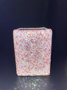Close-up of a luxury square makeup brush holder covered in pink and clear rhinestones