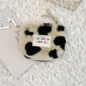 Detailed view of plush heart cow print pouch for earphones and cosmetics storage