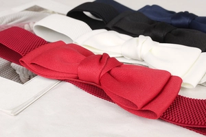 Detailed view of elastic bow belts in red, white, black and navy for dresses