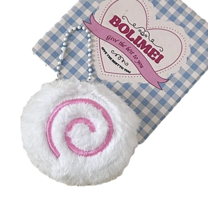 Cute white plush fish cake keychain with pink spiral embroidery on checkered background