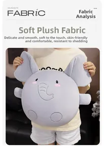 Detail of soft plush elephant pillow held by person showing smooth grey fabric texture