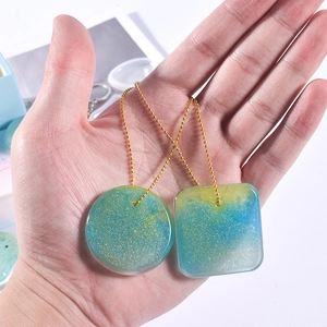 DIY silicone molds for resin heart and round pendants with gold glitter and ball chains