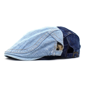 Detailed side view of light and dark blue washed denim ivy caps with contrast stitching