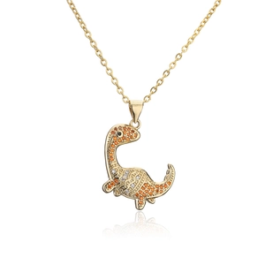 Detailed view of hip hop dinosaur pendant with gold plating and orange cubic zirconia