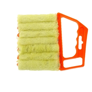 Orange handheld blind cleaner tool with seven green microfiber dusters on white background