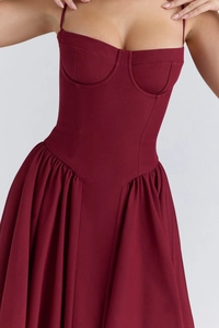 Detail of burgundy backless maxi dress featuring structured bust cups and waist cinching
