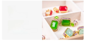 Detail of 12-layer gold-plated gemstone earrings with emerald and ruby zircon inlay