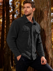 Close-up of black fleece jacket with shirt collar and symmetrical button pockets