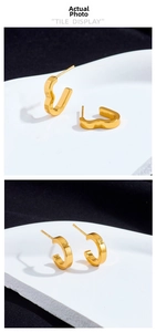 Detail of 18K gold titanium steel heart shaped earrings and minimalist C-shaped cuffs