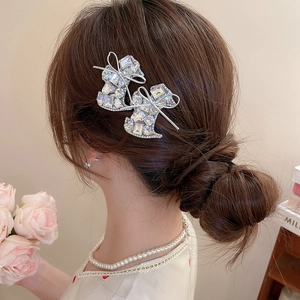 Sparkly rhinestone bow boot hair clip set on a female model for elegant styling