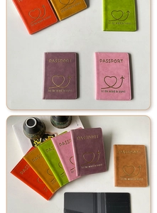 Close-up of colorful PU leather passport covers with gold stamped heart and airplane detail