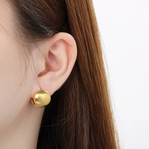 Minimalist gold hoop earrings with vertical ribbed texture and polished finish for women