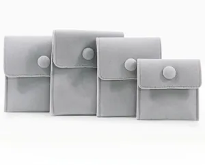 Detail view of gray velvet jewelry pouches in four sizes with snap button closure