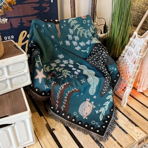 Bohemian outdoor camping blanket with teal sea life patterns and decorative fringe edges